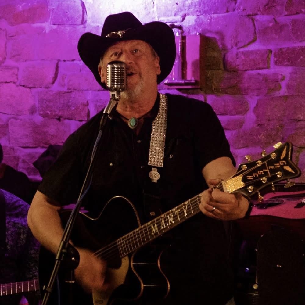 Marty Harris on stage with his guitar